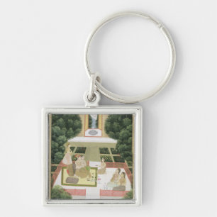 A couple in a garden listening to music with femal key ring