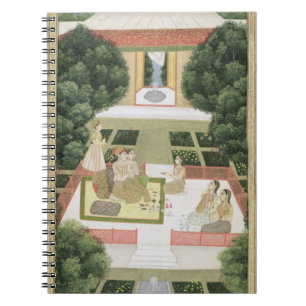 A couple in a garden listening to music with femal notebook