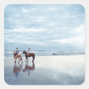 A couple riding horses on Parkiri beach in New Square Sticker