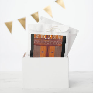 a cross stitch pattern in orange and brown favour bag