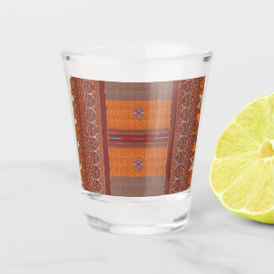 a cross stitch pattern in orange and brown shot glass