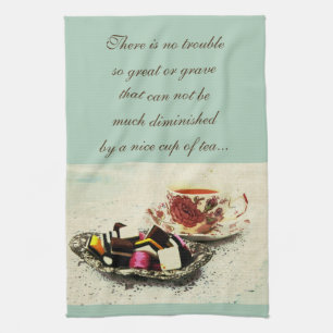 A cup of tea and sweets with quote towel