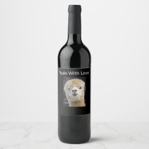A cute fluffy face of an alpaca wine label