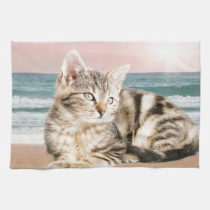 A Cuter Striped Cat Sitting on Beach with sunset Tea Towel