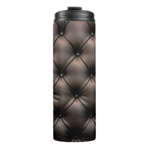 A dark leather cushion background, from a car seat thermal tumbler