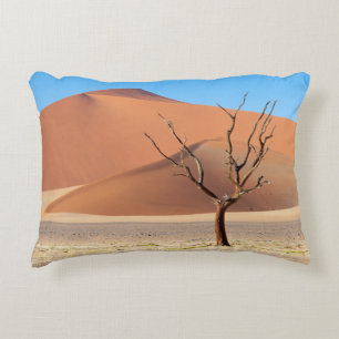 A dead tree on a desert plain with dunes decorative cushion
