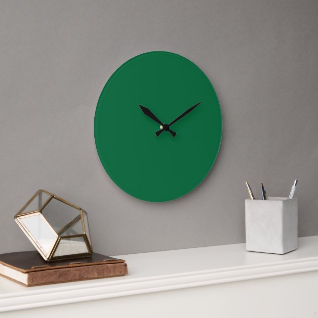 A deep green background contrasted by a crisp whit large clock (Office)