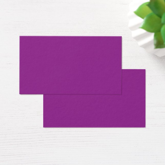 A deep purple background accented by a bright whit (Desk)