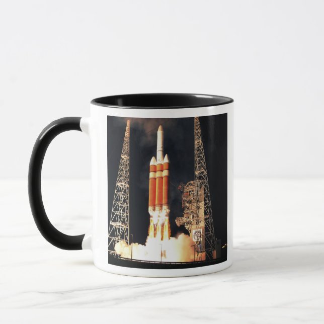 A Delta IV Heavy rocket lifts off Mug (Left)