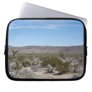 a desert landscape with some cactuses arround on laptop sleeve