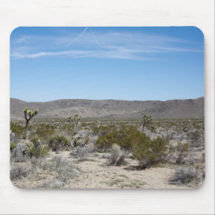a desert landscape with some cactuses arround on mouse pad