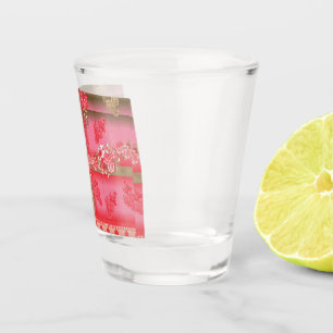 a design of a pink and gold background with a red shot glass