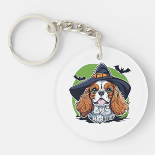 A dog wearing a witches hat with bats key ring