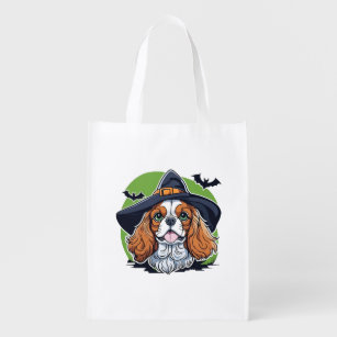 A dog wearing a witches hat with bats reusable grocery bag