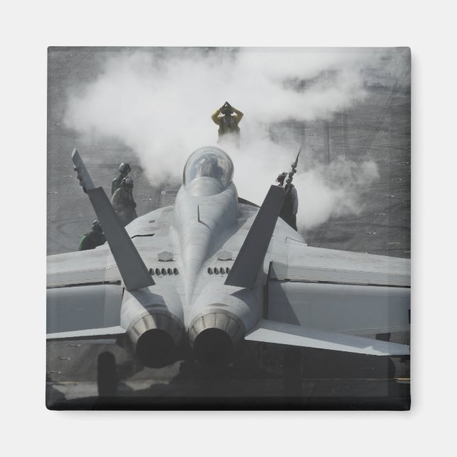 A flight deck director signals an F/A-18F Magnet (Front)