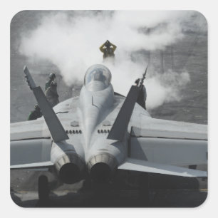 A flight deck director signals an F/A-18F Square Sticker