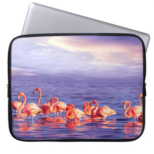 A flock of beautiful pink flamingos against a purp laptop sleeve