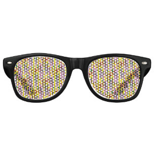 A fluffy grey cat with green eyes sits on a window retro sunglasses