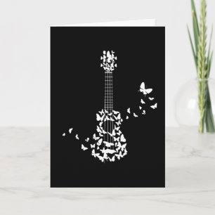 A Four String Ukulele Instrument With Beautiful Card