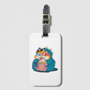 A funny hamster wearing glasses eats popcorn luggage tag