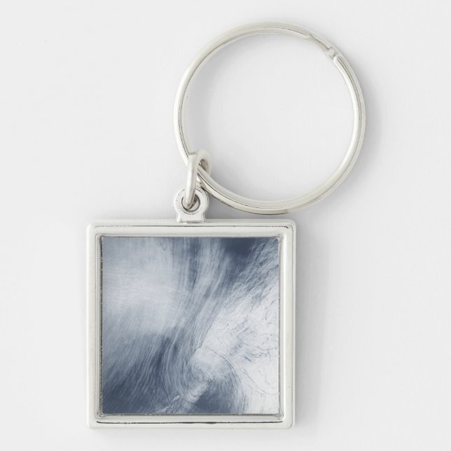 A giant whirlpool cloud swirls above the sea key ring (Front)