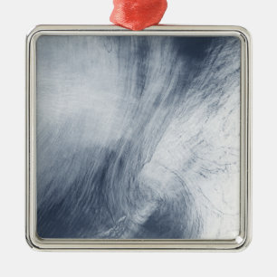 A giant whirlpool cloud swirls above the sea metal tree decoration