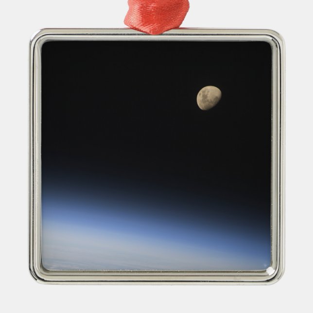 A gibbous moon visible above Earth's atmosphere Metal Ornament (Front)