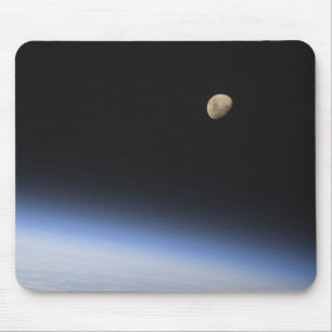 A gibbous moon visible above Earth's atmosphere Mouse Pad