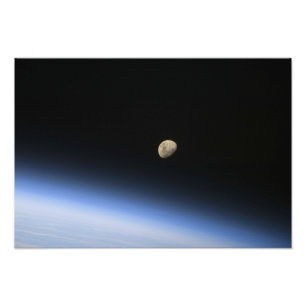 A gibbous moon visible above Earth's atmosphere Photo Print