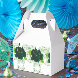 A golden retriever puppy sits on a grassy field, w favour box
