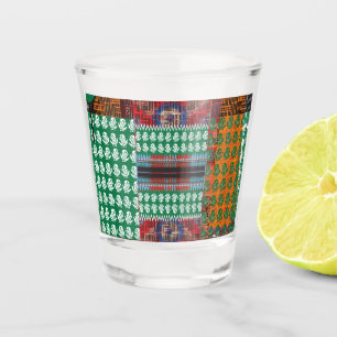a green and black pattern with a tree in the middl shot glass