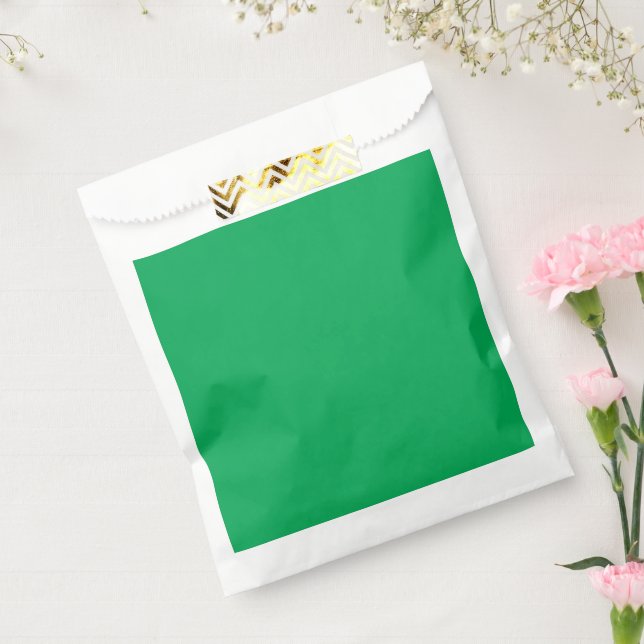 a green background with a favour bag (Sealed)