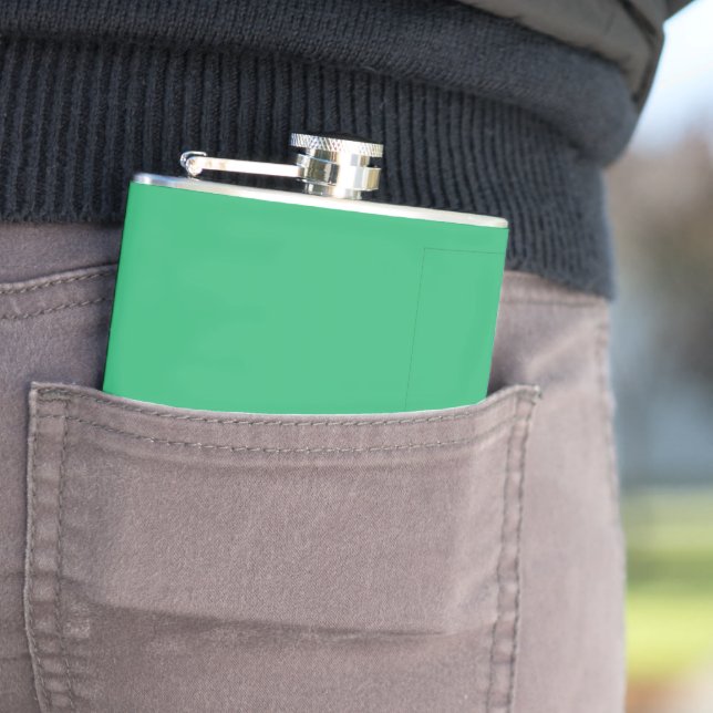 a green background with a white border hip flask (In Situ)