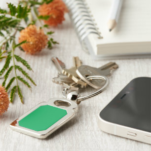 a green background with a white border key ring
