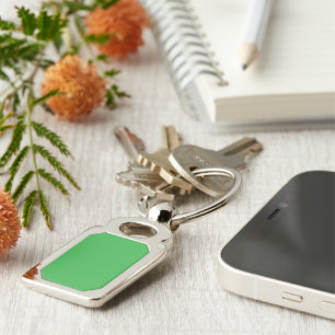 a green background with a white border key ring
