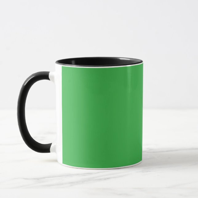 a green background with a white border mug (Left)