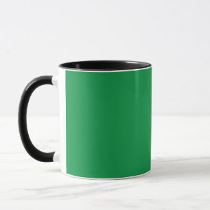 a green background with a white border mug
