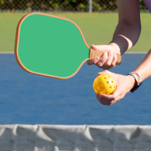 a green background with a white border pickleball paddle