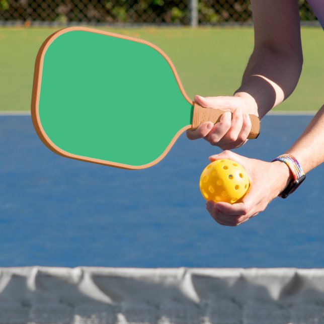 a green background with a white border pickleball paddle (Insitu)