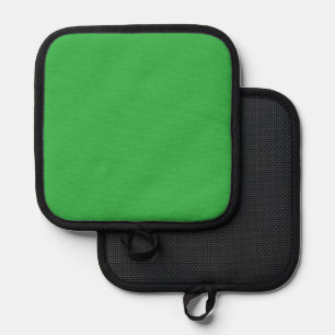 a green background with a white border pot holder