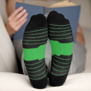 a green background with a white border socks