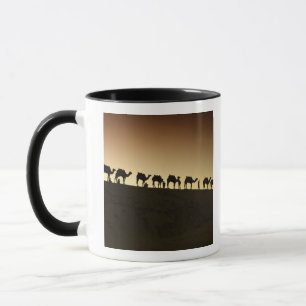 A group of camel herders with their camels mug