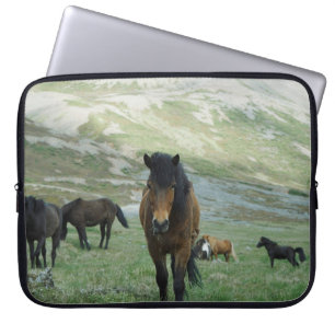 A GROUP OF HORSES ON A MOUNTAIN PASTURE LAPTOP SLEEVE