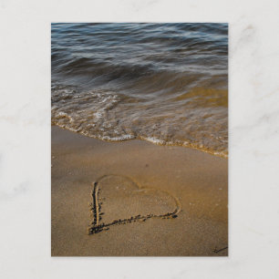 A heart on sand and in rainbow colours postcard