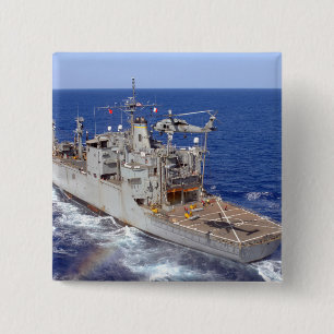 A helicopter clears the flight deck 15 cm square badge