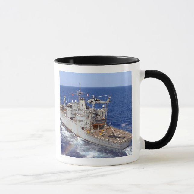 A helicopter clears the flight deck mug (Right)