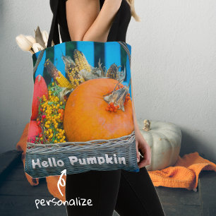 A holiday basket with pumpkins tote bag