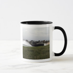 A landing craft air cushion comes ashore mug