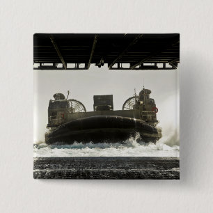 A landing craft air cushion prepares to enter 15 cm square badge