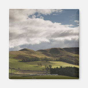 A Landscape With Rolling Hills And Clouds Overhead Magnet